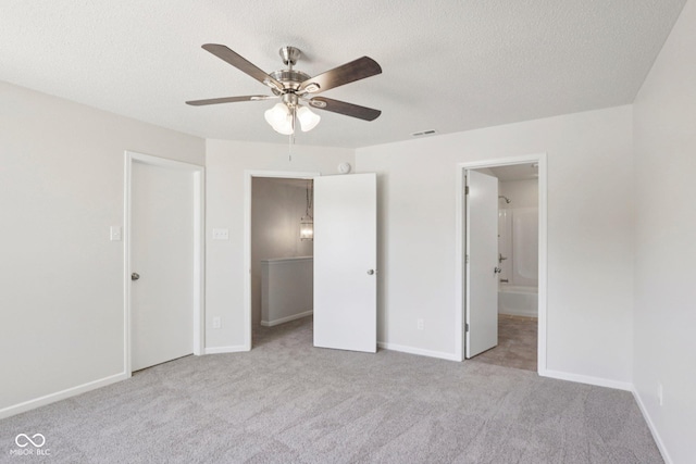 2629 Redland Ln, Indianapolis, IN 46217 - unfurnished bedroom featuring carpet floors, a textured ceiling, connected bathroom, and ceiling fan