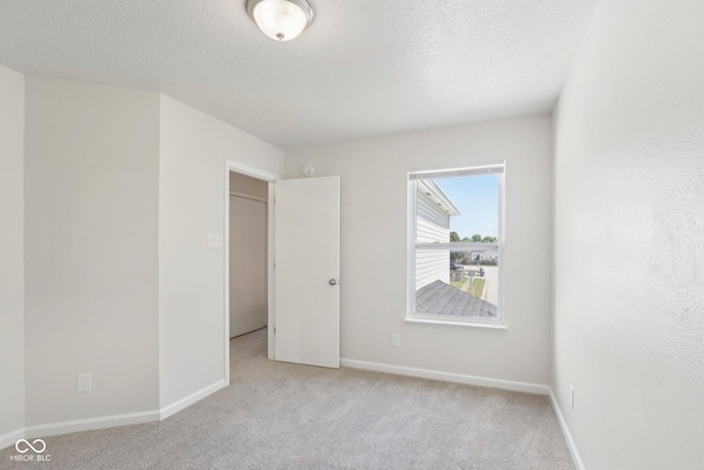 2629 Redland Ln, Indianapolis, IN 46217 - spare room featuring light carpet and a textured ceiling