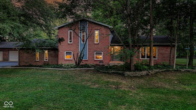 812 Eaglewood Dr, Zionsville, IN 46077 - view of front of home featuring brick siding, a front lawn, an attached garage, and driveway