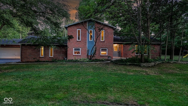 812 Eaglewood Dr, Zionsville, IN 46077 - view of front of home featuring brick siding, a front yard, a garage, and driveway