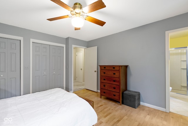 812 Eaglewood Dr, Zionsville, IN 46077 - bedroom with light wood-style flooring, two closets, ensuite bathroom, and ceiling fan