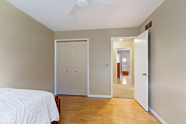 812 Eaglewood Dr, Zionsville, IN 46077 - bedroom with light wood finished floors, a closet, and a ceiling fan