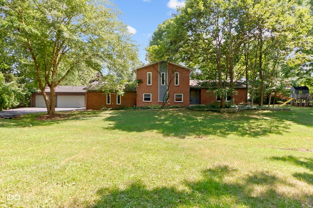 812 Eaglewood Dr, Zionsville, IN 46077 - view of front of property with a garage, brick siding, a front lawn, and a playground