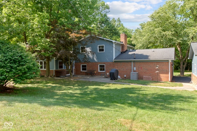 812 Eaglewood Dr, Zionsville, IN 46077 - rear view of property featuring brick siding, a chimney, a patio, and a yard