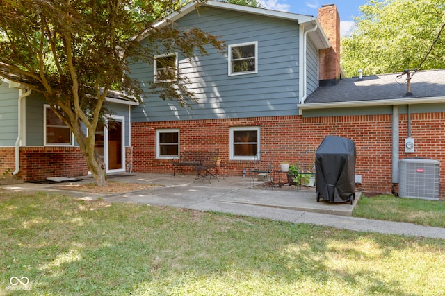 812 Eaglewood Dr, Zionsville, IN 46077 - back of house featuring a chimney, brick siding, a yard, and a patio area