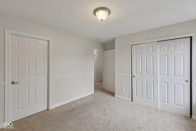 1272 Townsend Dr, Greenwood, IN 46143 - unfurnished bedroom featuring carpet flooring, a closet, and a textured ceiling