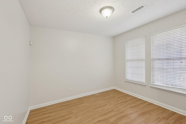 1272 Townsend Dr, Greenwood, IN 46143 - spare room featuring light wood-type flooring and a textured ceiling