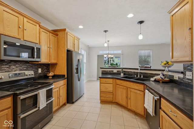 1272 Townsend Dr, Greenwood, IN 46143 - kitchen featuring stainless steel appliances, tasteful backsplash, light tile patterned floors, dark countertops, and recessed lighting