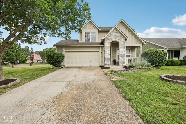 1272 Townsend Dr, Greenwood, IN 46143 - craftsman-style home featuring board and batten siding, stone siding, a front lawn, and driveway