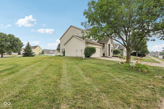 1272 Townsend Dr, Greenwood, IN 46143 - view of side of home with an attached garage, a lawn, and driveway