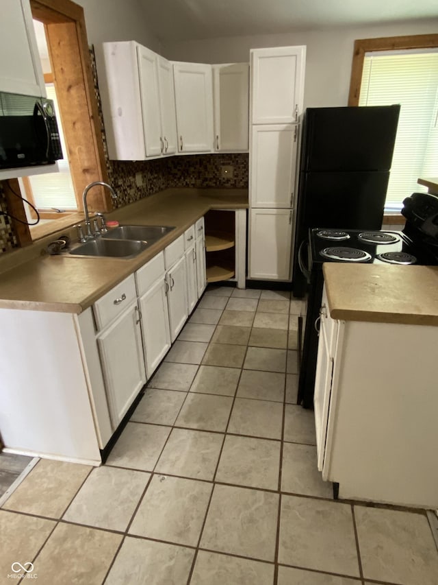 3170 Sapphire Blvd, Indianapolis, IN 46268 - kitchen with black appliances, white cabinets, light tile patterned floors, and tasteful backsplash
