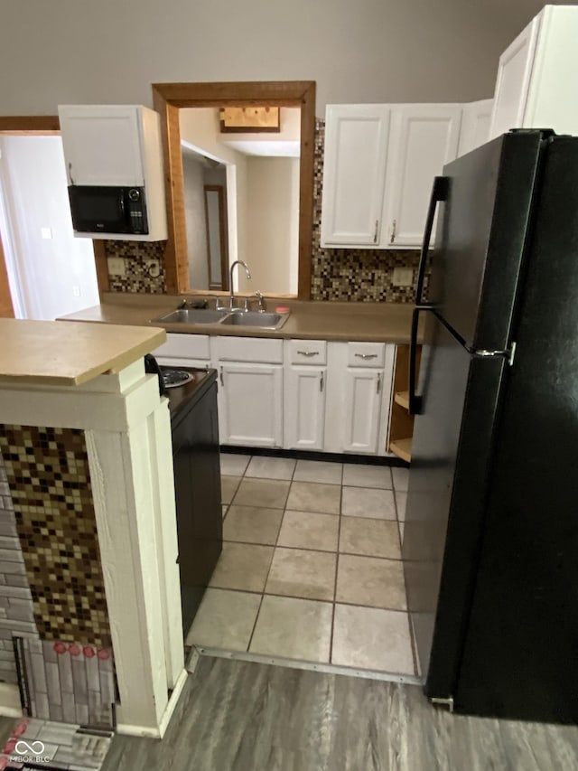 3170 Sapphire Blvd, Indianapolis, IN 46268 - kitchen featuring black appliances, decorative backsplash, and white cabinets