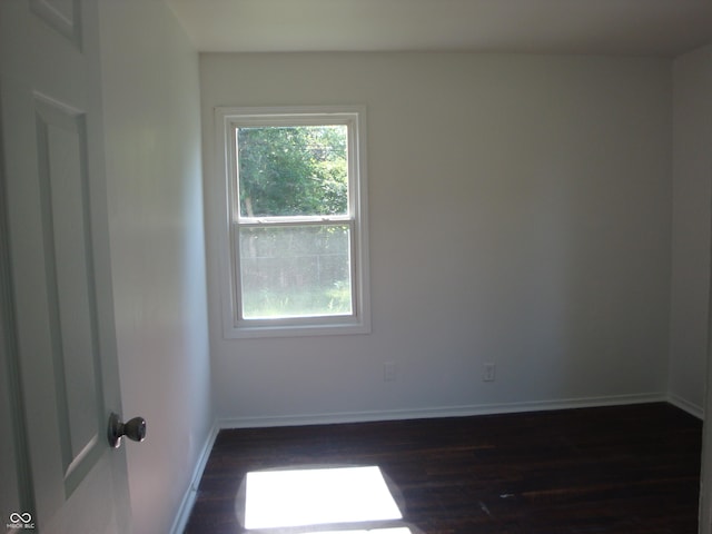3448 Georgetown Rd, Indianapolis, IN 46224 - spare room featuring dark wood-style flooring and baseboards
