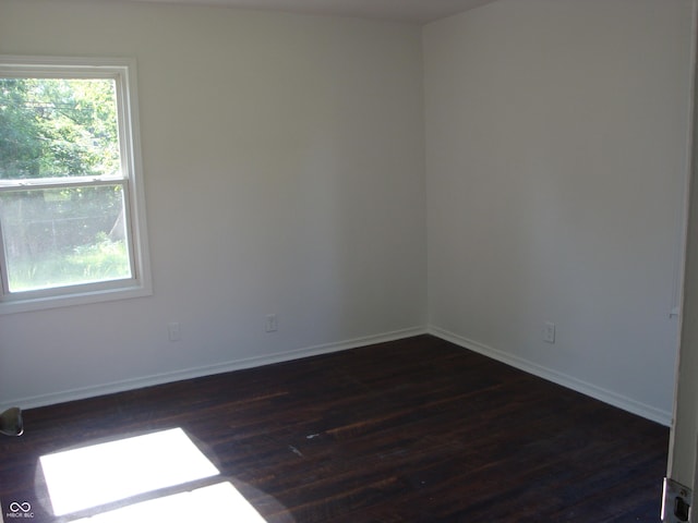 3448 Georgetown Rd, Indianapolis, IN 46224 - empty room with dark wood finished floors and baseboards