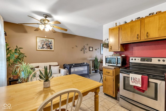3909 Richelieu Ct, Indianapolis, IN 46226 - kitchen featuring stainless steel appliances, ceiling fan, light tile patterned flooring, and brown cabinetry