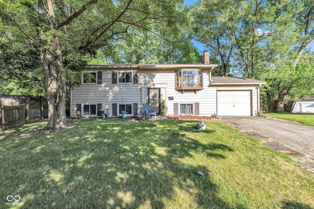 3909 Richelieu Ct, Indianapolis, IN 46226 - bi-level home with a chimney, concrete driveway, and an attached garage