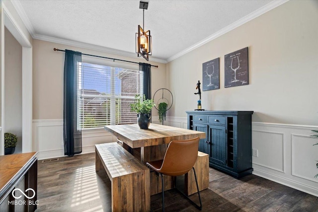 11322 Sea Side Ct, Fishers, IN 46040 - dining room featuring dark wood-style flooring, wainscoting, healthy amount of natural light, crown molding, and a chandelier