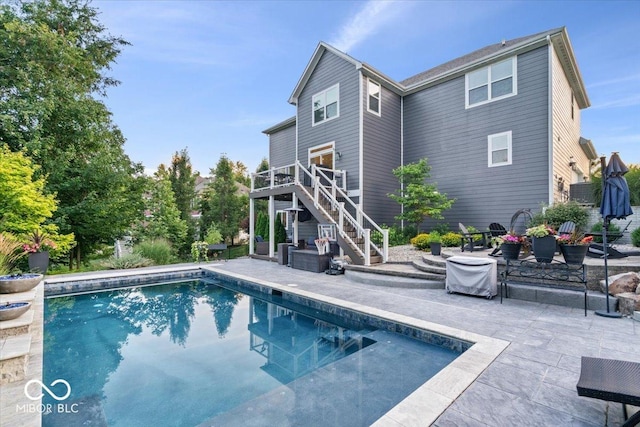 11322 Sea Side Ct, Fishers, IN 46040 - rear view of property with stairway, a patio, a wooden deck, and an outdoor pool