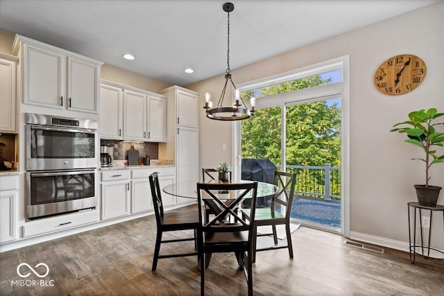 11322 Sea Side Ct, Fishers, IN 46040 - dining room with a chandelier, light wood-style floors, and recessed lighting