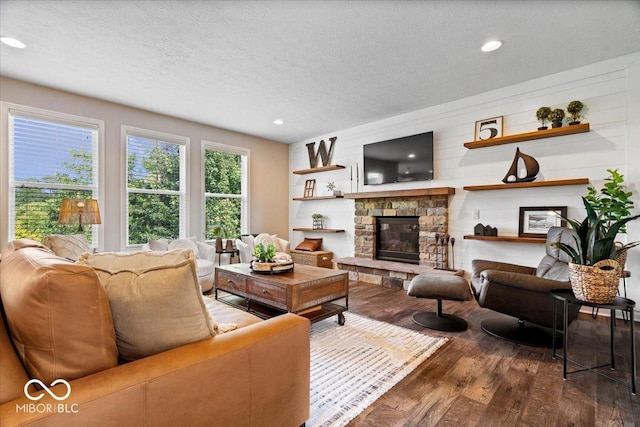 11322 Sea Side Ct, Fishers, IN 46040 - living area featuring wood finished floors, a textured ceiling, a stone fireplace, and recessed lighting