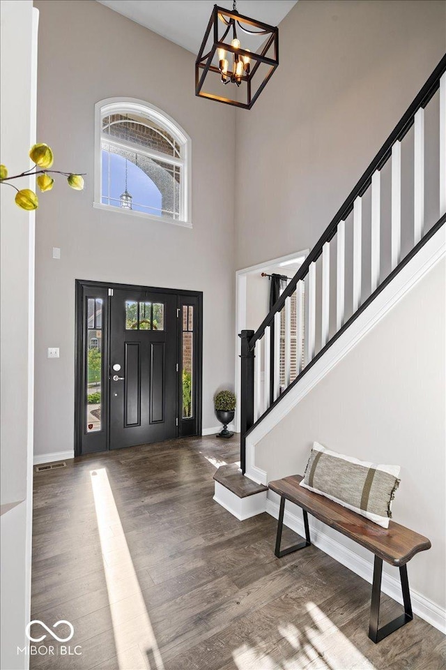 11322 Sea Side Ct, Fishers, IN 46040 - foyer entrance featuring wood finished floors, stairs, a chandelier, and a towering ceiling