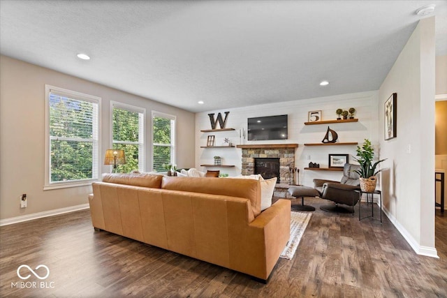 11322 Sea Side Ct, Fishers, IN 46040 - living room with dark wood-type flooring, a stone fireplace, and recessed lighting