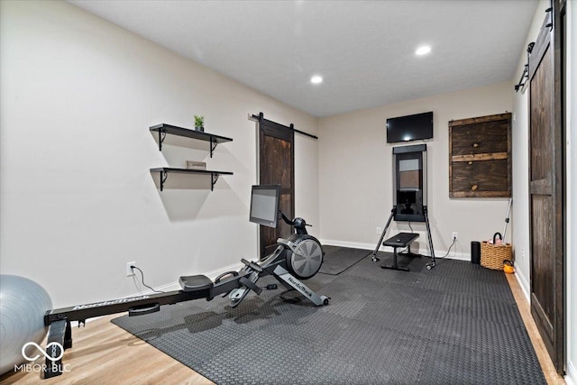 11322 Sea Side Ct, Fishers, IN 46040 - exercise room featuring a barn door and recessed lighting