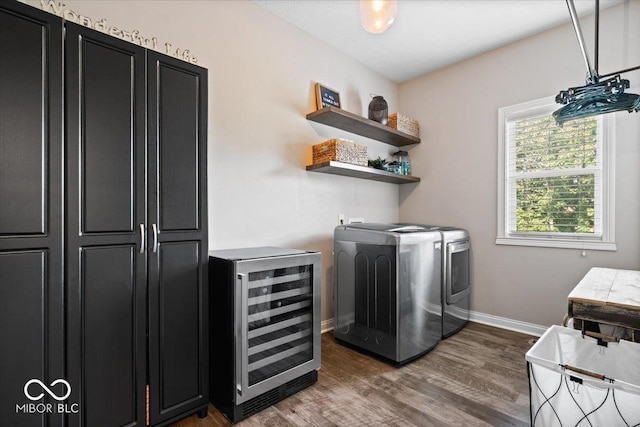 11322 Sea Side Ct, Fishers, IN 46040 - laundry area with beverage cooler, washing machine and dryer, wood finished floors, and a dry bar