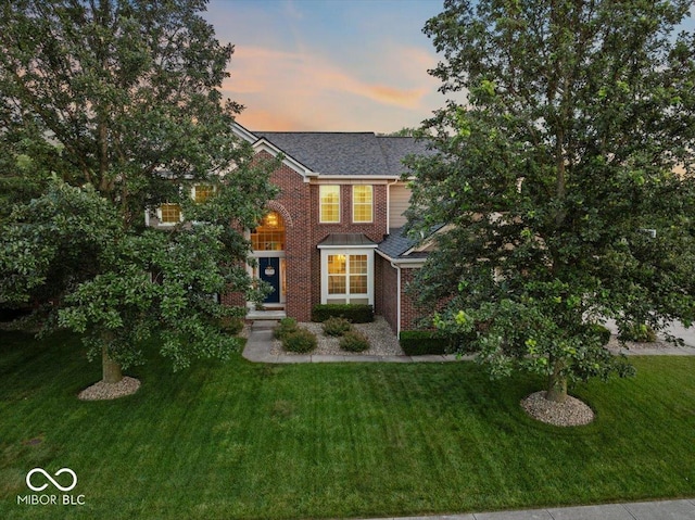 13059 Cirrus Dr, Fishers, IN 46037 - view of front facade featuring brick siding, a yard, and roof with shingles