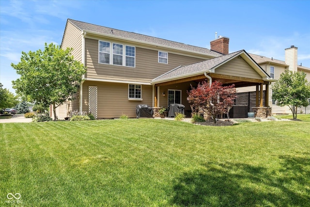 13059 Cirrus Dr, Fishers, IN 46037 - rear view of property with a yard, a chimney, and roof with shingles