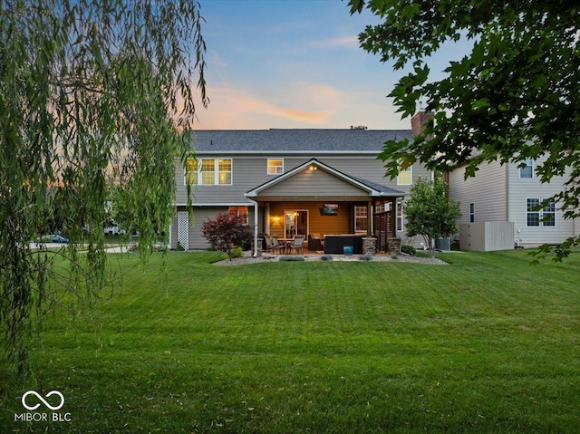 13059 Cirrus Dr, Fishers, IN 46037 - back of house featuring a yard, a patio area, an outdoor living space, and a chimney