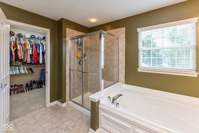 13059 Cirrus Dr, Fishers, IN 46037 - bathroom featuring a garden tub, a stall shower, and a spacious closet