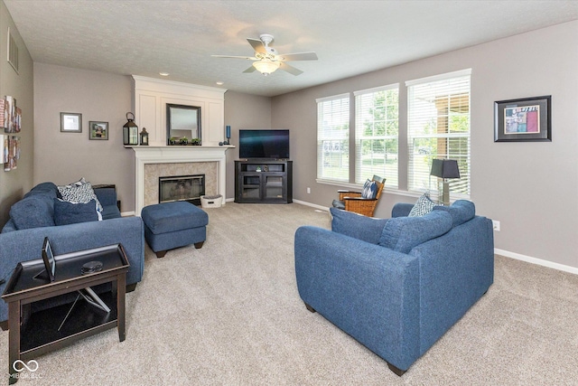 13059 Cirrus Dr, Fishers, IN 46037 - living room featuring light carpet, a ceiling fan, and a glass covered fireplace
