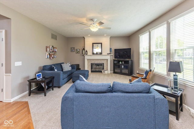 13059 Cirrus Dr, Fishers, IN 46037 - living area with light colored carpet, a ceiling fan, and a large fireplace