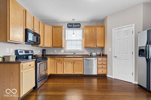 16009 Tenor Way, Noblesville, IN 46060 - kitchen featuring stainless steel appliances, dark countertops, pendant lighting, dark wood-style flooring, and a textured ceiling
