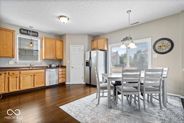 16009 Tenor Way, Noblesville, IN 46060 - kitchen featuring refrigerator with ice dispenser, dishwasher, healthy amount of natural light, dark countertops, and a textured ceiling