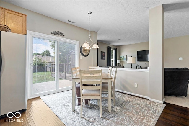 16009 Tenor Way, Noblesville, IN 46060 - dining area with wood finished floors, a chandelier, and a textured ceiling