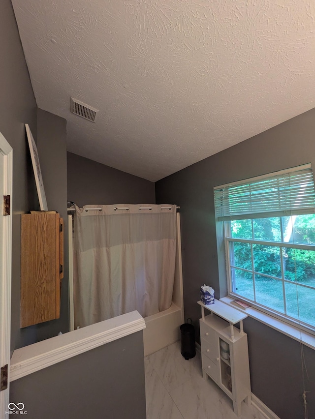 7327 Newbury Ct, Fishers, IN 46038 - bathroom with marble finish flooring, shower / bath combo, and a textured ceiling