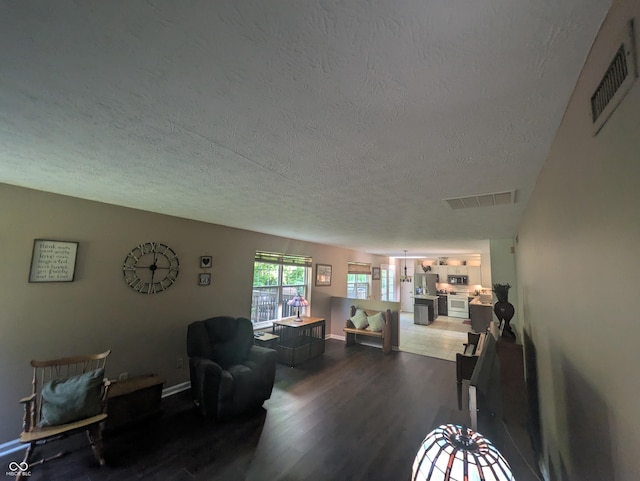 7327 Newbury Ct, Fishers, IN 46038 - living room featuring a textured ceiling and dark wood-style floors
