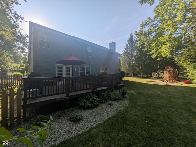 7327 Newbury Ct, Fishers, IN 46038 - rear view of property with a lawn, a deck, a chimney, and a playground