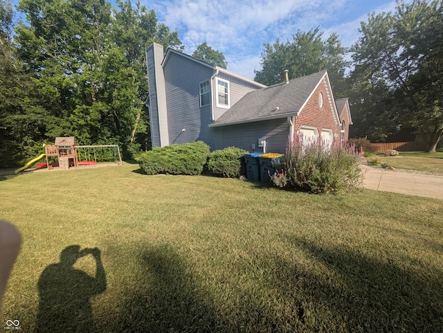 7327 Newbury Ct, Fishers, IN 46038 - view of property exterior featuring a playground, a chimney, a yard, and an attached garage