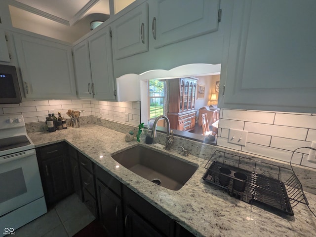 7327 Newbury Ct, Fishers, IN 46038 - kitchen featuring electric range, stainless steel microwave, backsplash, and light stone counters