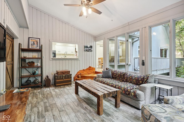 118 White Horse Ln, Fishers, IN 46038 - living room featuring vaulted ceiling, hardwood / wood-style floors, a ceiling fan, and wooden walls