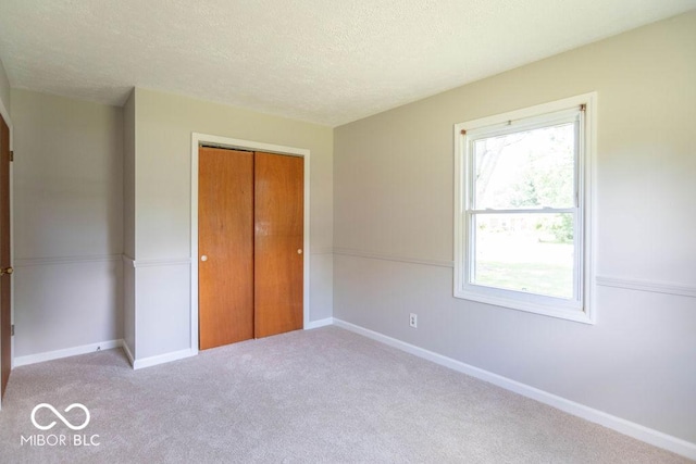 1189 N County Road 475 E, Avon, IN 46123 - unfurnished bedroom with carpet, a closet, and a textured ceiling