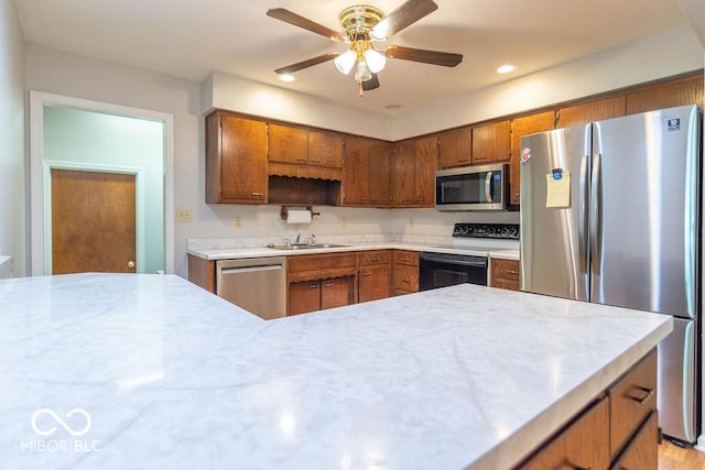 1189 N County Road 475 E, Avon, IN 46123 - kitchen featuring appliances with stainless steel finishes, brown cabinets, light countertops, recessed lighting, and ceiling fan