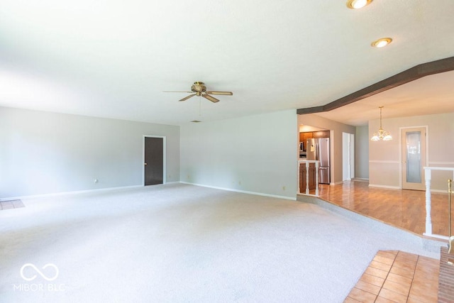 1189 N County Road 475 E, Avon, IN 46123 - unfurnished living room featuring light colored carpet, a chandelier, and ceiling fan