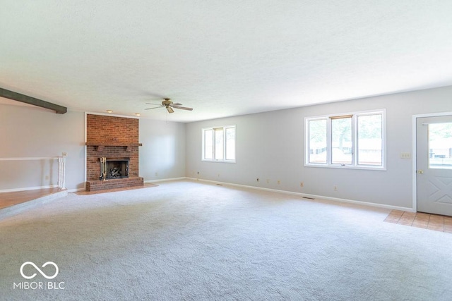 1189 N County Road 475 E, Avon, IN 46123 - unfurnished living room featuring ceiling fan, light colored carpet, a fireplace, and a textured ceiling