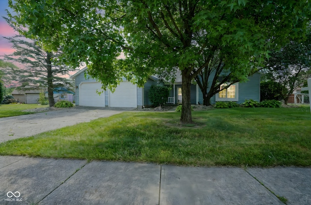 8809 Haddington Dr N, Indianapolis, IN 46256 - view of property hidden behind natural elements featuring an attached garage, concrete driveway, and a front yard