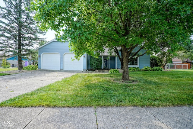8809 Haddington Dr N, Indianapolis, IN 46256 - obstructed view of property featuring an attached garage, driveway, and a front lawn