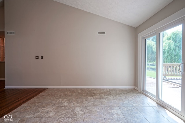 8809 Haddington Dr N, Indianapolis, IN 46256 - spare room with lofted ceiling and a textured ceiling